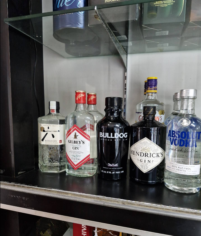 Selection of gins and vodka including Hendrick’s, Bulldog, Gilbey’s and Absolut on display.